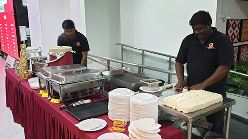 Staff preparing prata dough at Springleaf Prata Place